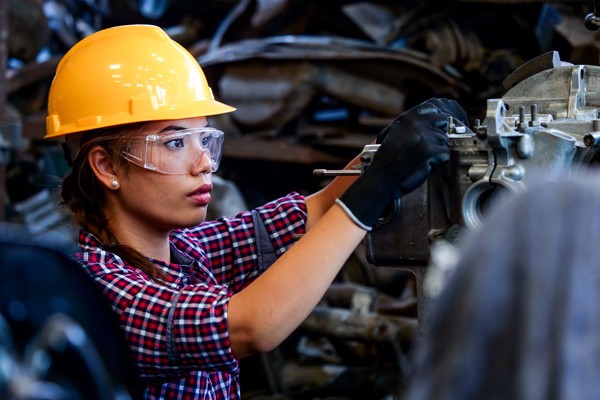 Woman working on engine