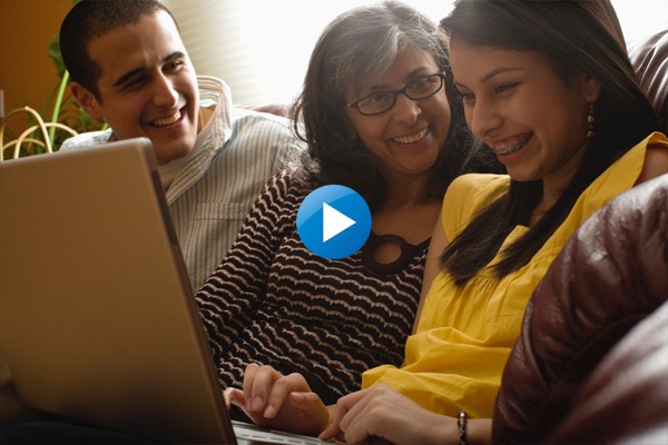 Parents and student looking at laptop